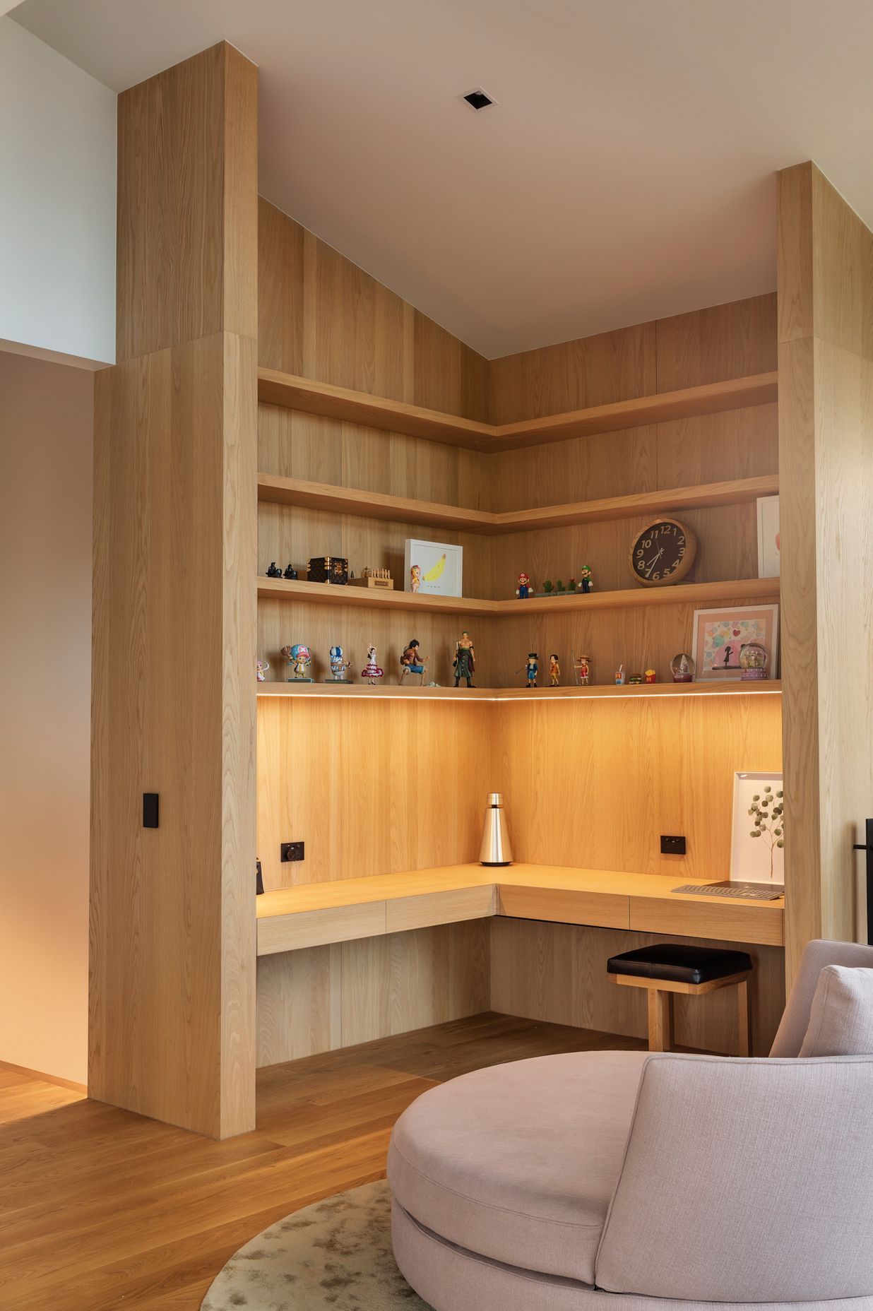 The study features built-in oak cabinetry with hidden drawers in the benchtop.