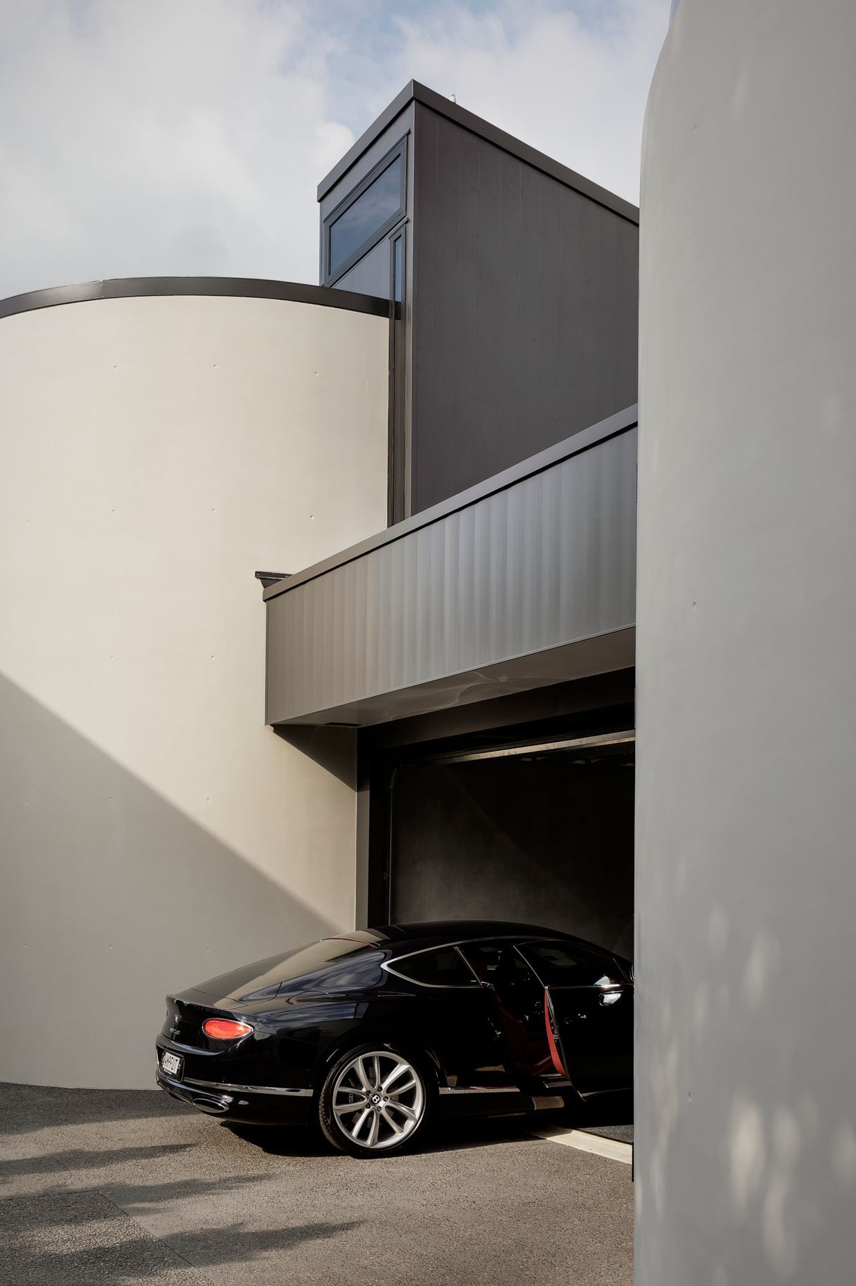 Curved insitu concrete walls either side of the garage provide ample turning space.