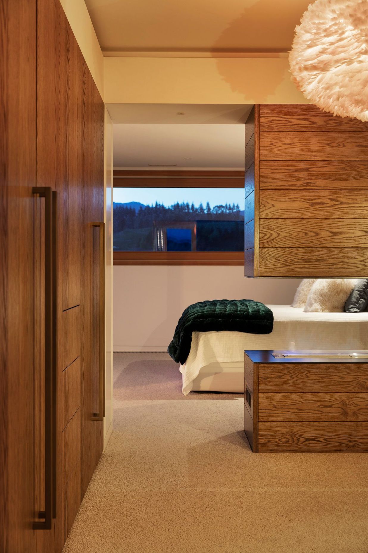 The master suite utilises bespoke oak cabinetry for plenty of storage.