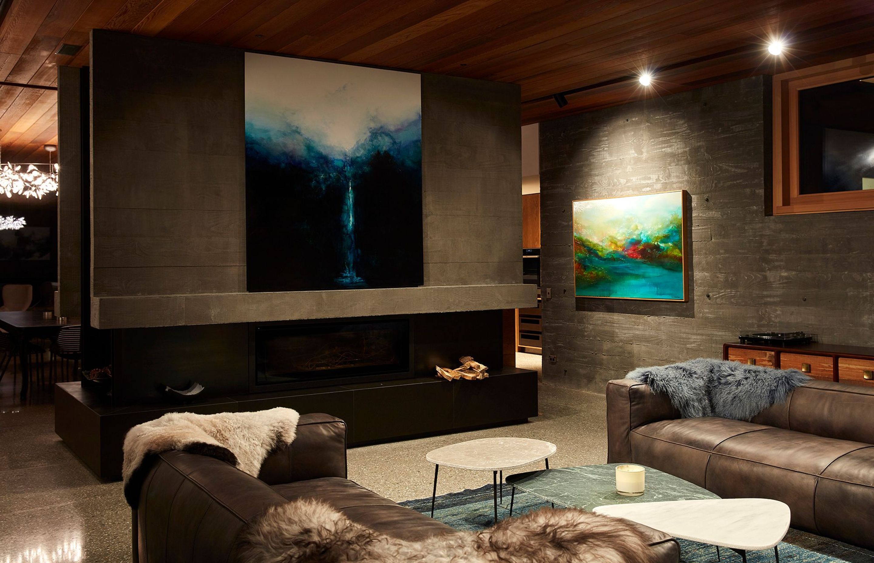 The divider becomes a focal point to feature art and a fireplace.