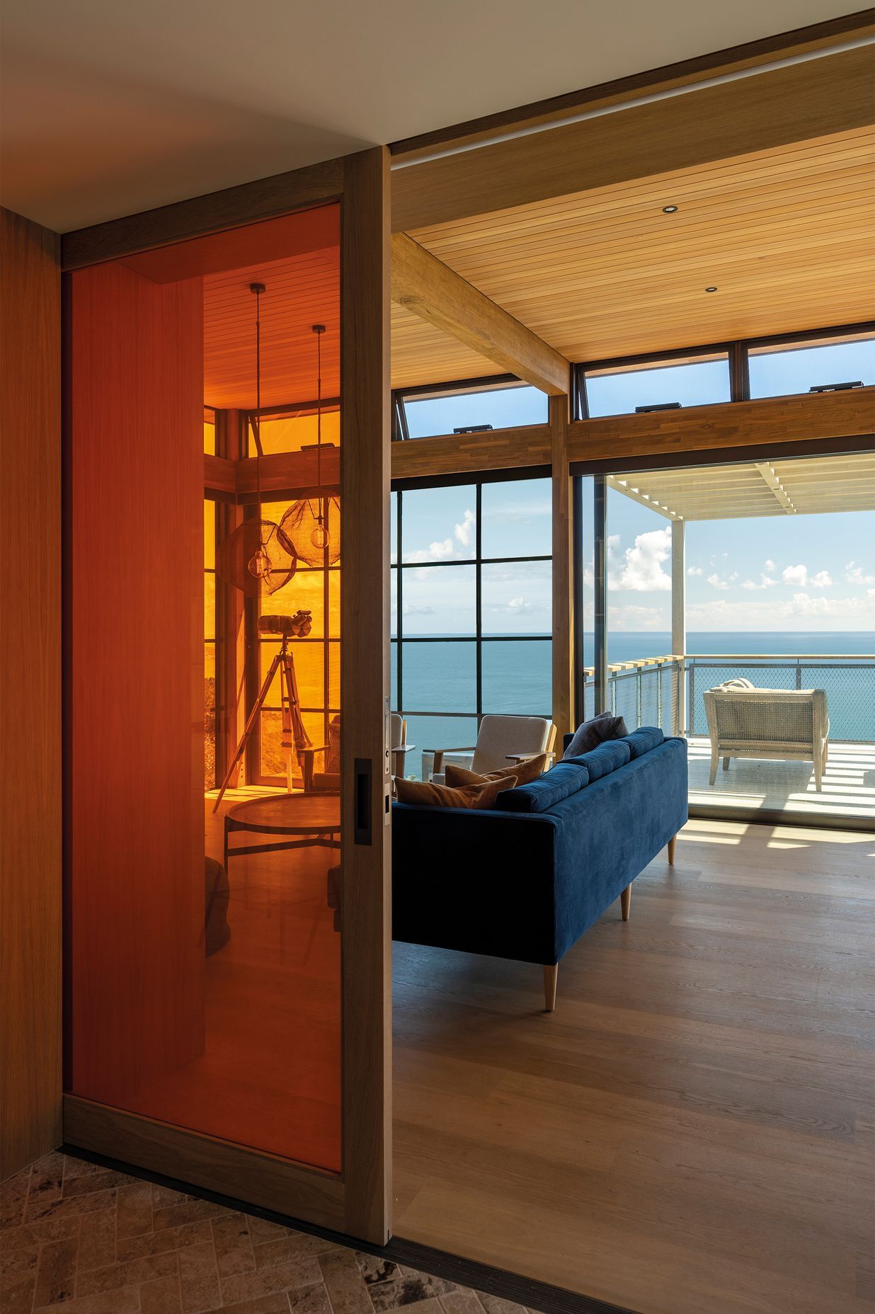 A vibrant tangerine door can be used to separate the living area.