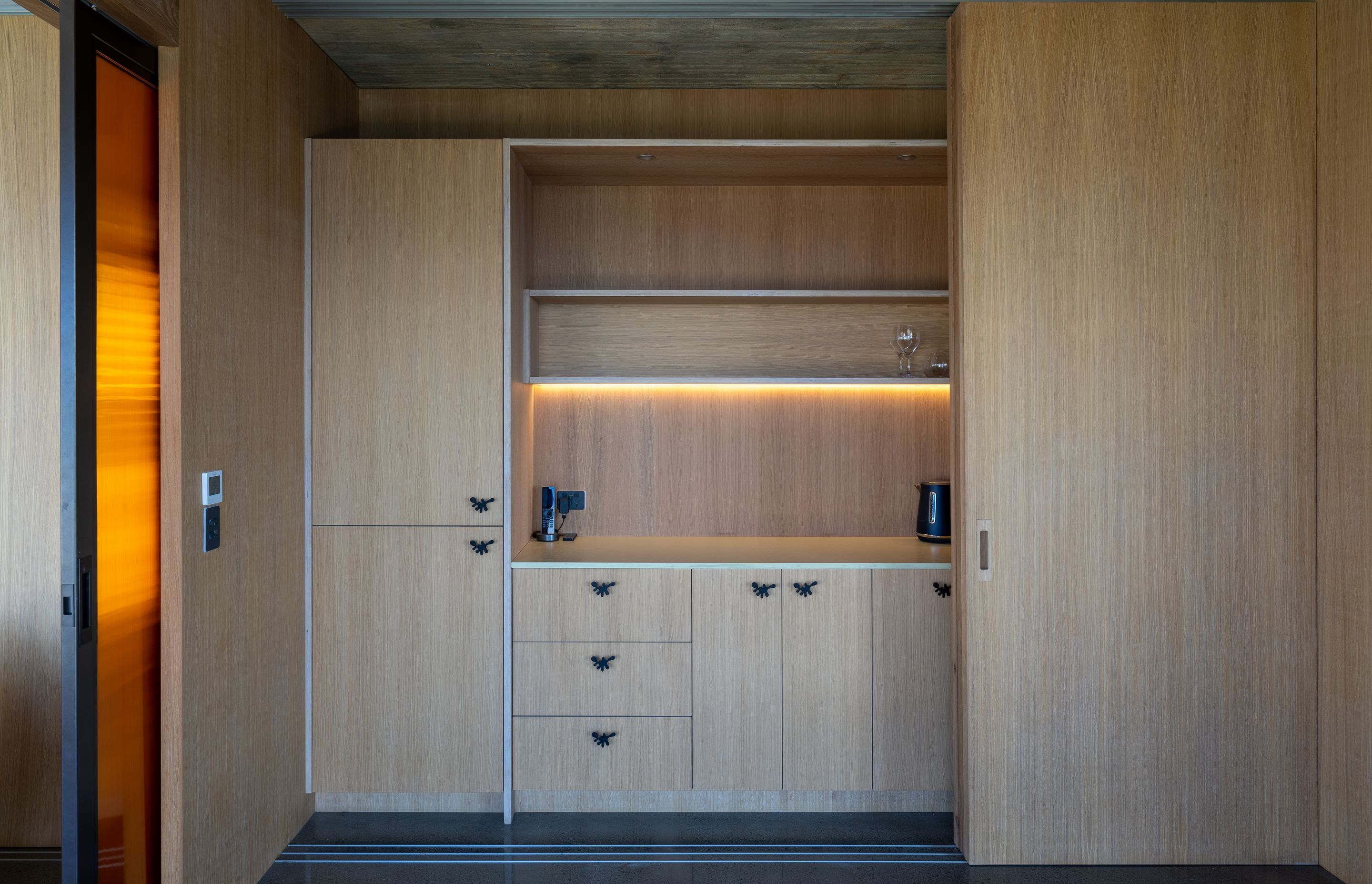 A kitchenette and storage have been incorporated into the downstairs multifunctional space.