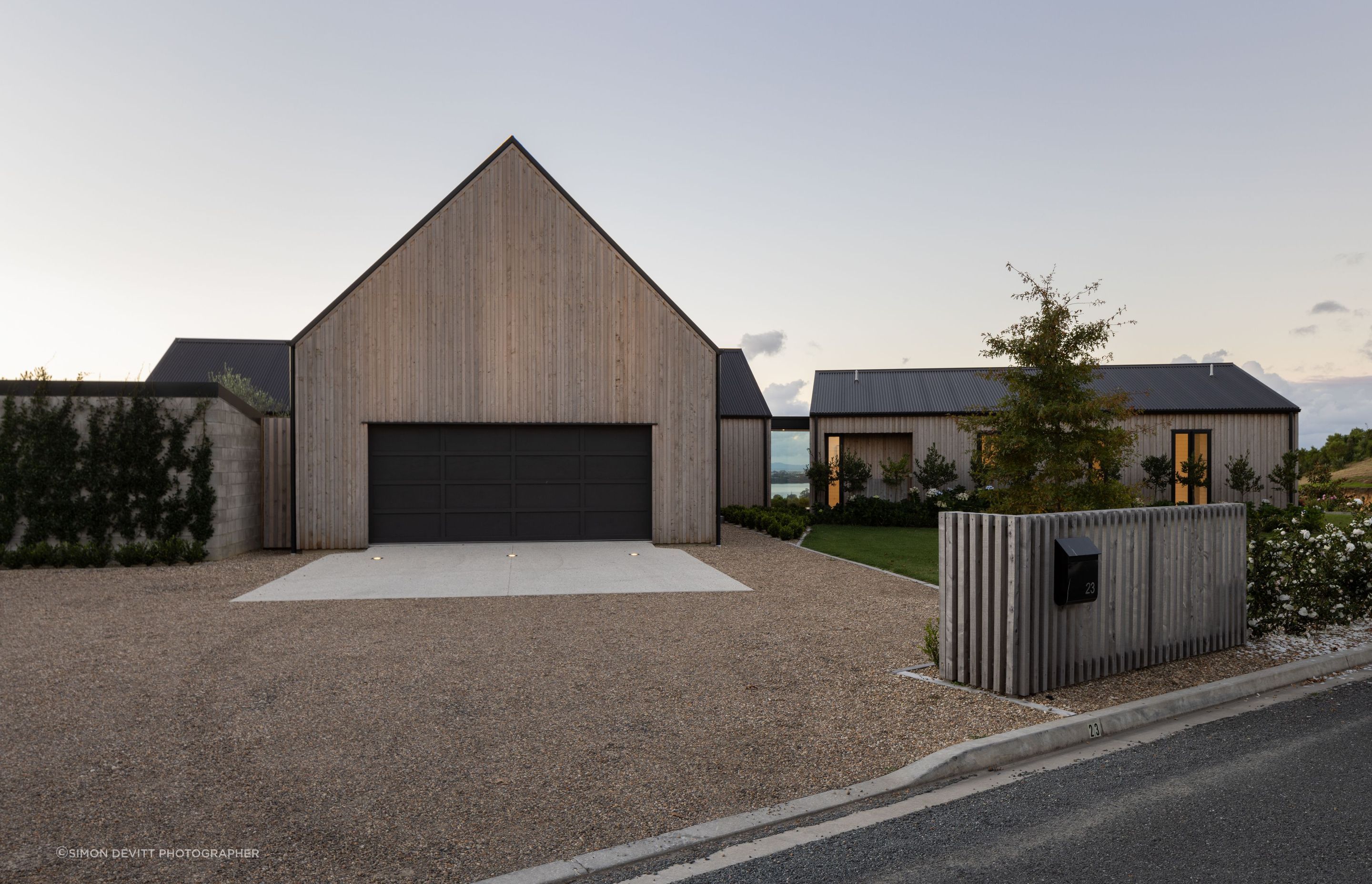 The gable form of the garage pod cuts a distinct shape upon arrival.