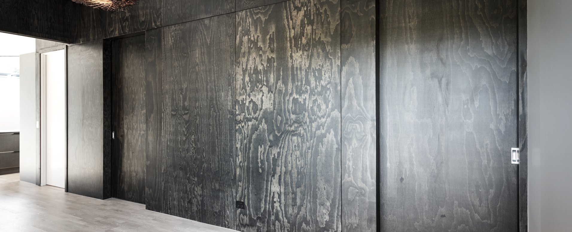 A striking feature wall in black satin plywood by Bates Surfaces