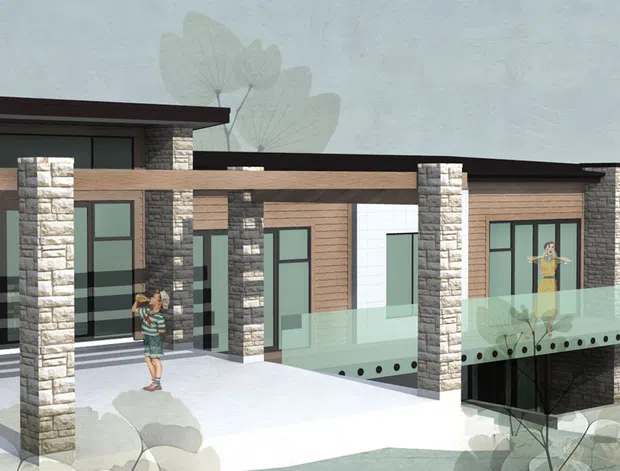 Architectural rendering of a low, modern multi-level residence with a broad flat roof, extensive dark-framed glazing, projecting timber-toned horizontal elements, and repeated stone-clad structural columns. A glazed balcony or terrace extends over a lower-level opening, with a light concrete forecourt and landscaped vegetation around the building.
